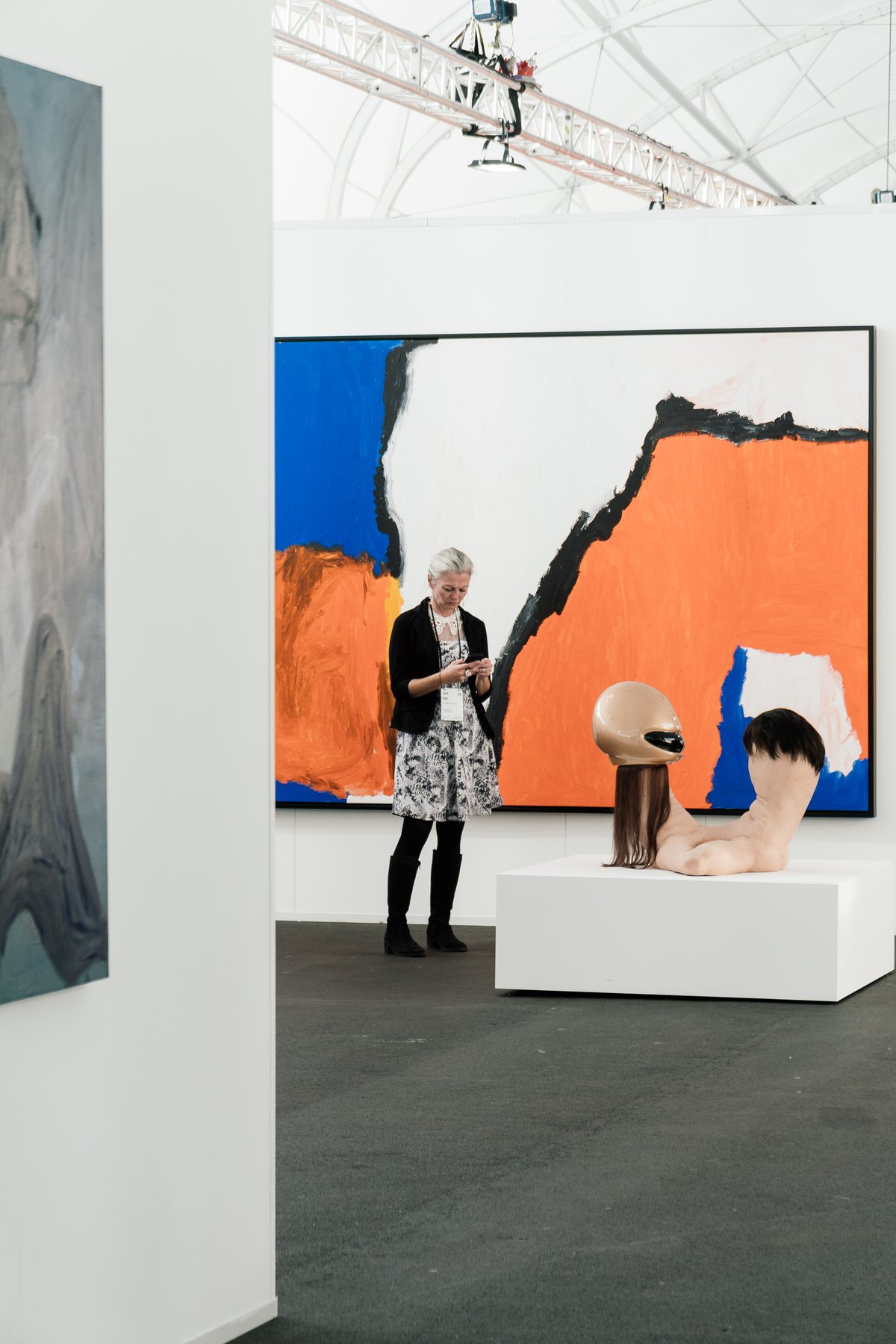 Art fair interior with visitors and artworks