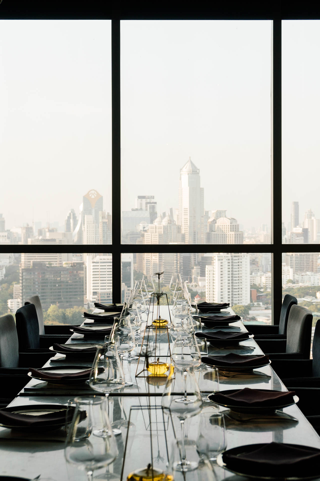 Restaurant interior overlooking a city skyline